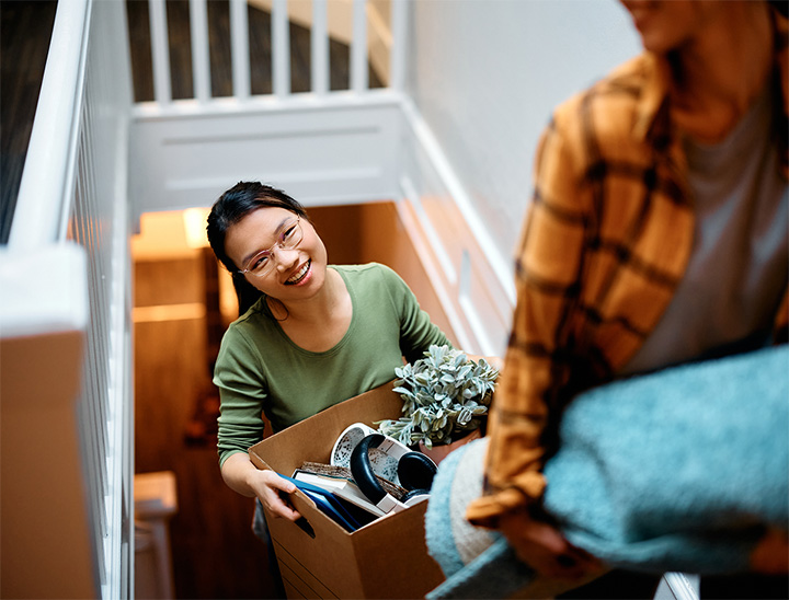 Image of young couple moving into a home.